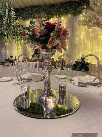 Silver Pillar Candlestick with Flowers for hire, centrepieces by Bows Hire